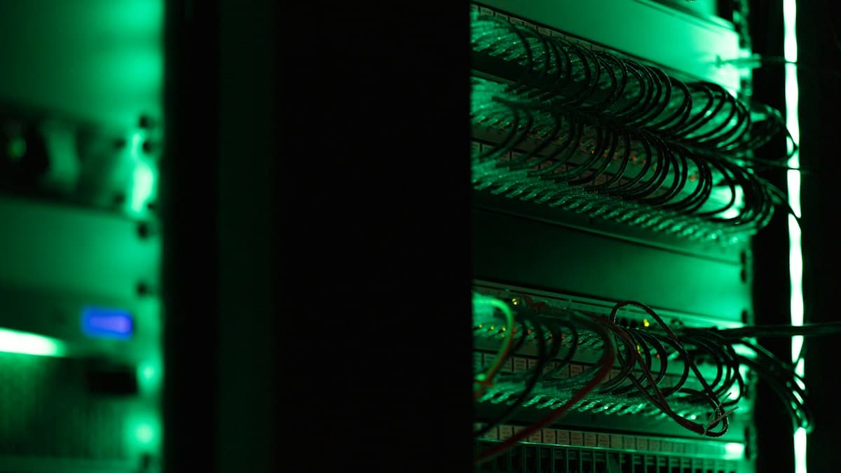 Rack of networking equipment in a dark server room